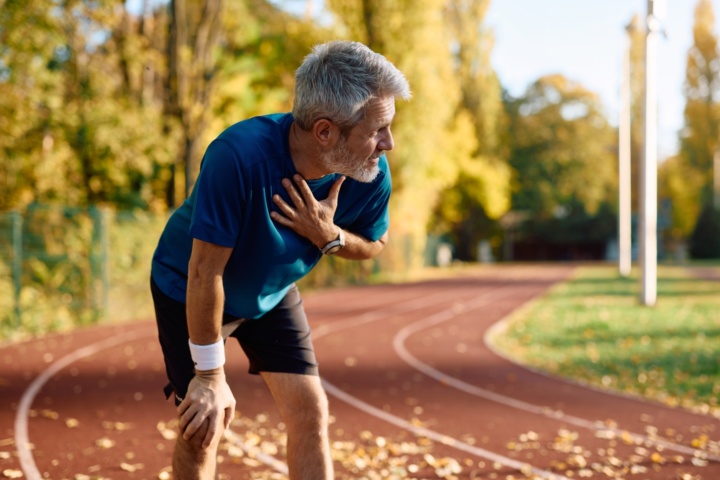 Tired,Mature,Sportsman,Catching,His,Breath,While,Running,Outdoors,In
